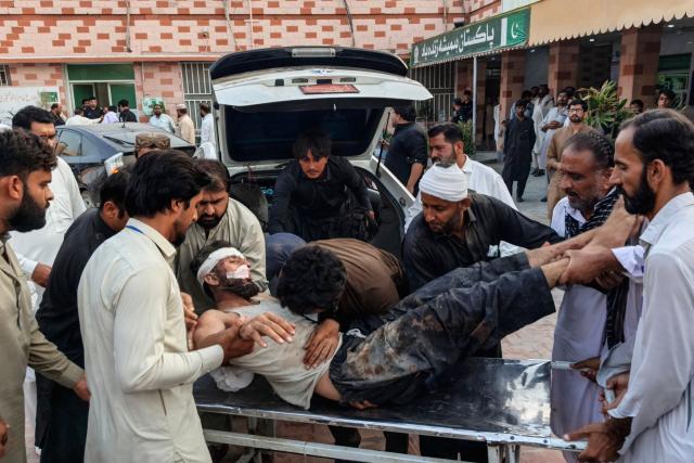 EDITORS NOTE: Graphic content / People carry an injured blast victim inside a hospital at Dera Ismail Khan in Pakistan's Khyber Pakhtunkhwa province on September 26, 2026. Militants rammed an explosives-laden vehicle into a security check post in northern Pakistan, killing at least 11 people and wounding 18 others, police and rescue officials said September 26. (Photo by Mohammad Kashif / AFP)
