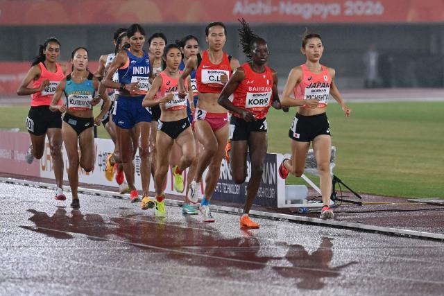 (R-L) Japan's Mizuki Michishita, Bahrain's Nelly Korir, China's Li Chunhui, Japan's Nozomi Tanaka, India's Parul Chaudhary, Kazakhstan's Aiana Bolatbekkyzy and Nepal's Purna Neupane compete in the women's 1500m final during the 2026 Asian Games at Nagoya City Mizuho Park Athletic Stadium in Nagoya, Aichi Prefecture on September 26, 2026. (Photo by MOHD RASFAN / AFP)