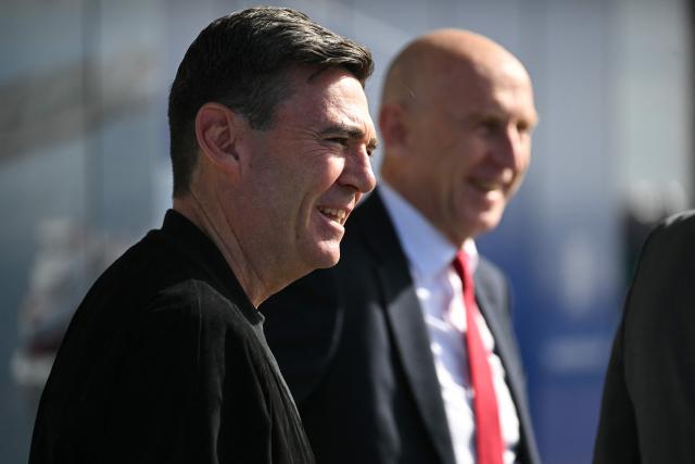 Britain's Prime Minister Andy Burnham (L) and Britain's Chancellor of the Exchequer John Healey (R) go to see the new ferry ahead of the annual Labour Party conference in Liverpool, north-west England, on September 26, 2026. Britain's ruling Labour Party gathers Sunday for its first annual conference under Andy Burnham's leadership, heartened by his start as prime minister but now looking for concrete plans to tackle looming challenges. (Photo by Oli SCARFF / AFP)