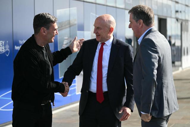 Liverpool mayor Steve Rotheram (R), Britain's Prime Minister Andy Burnham (L) and Britain's Chancellor of the Exchequer John Healey (C) go to see the new ferry ahead of the annual Labour Party conference in Liverpool, north-west England, on September 26, 2026. Britain's ruling Labour Party gathers Sunday for its first annual conference under Andy Burnham's leadership, heartened by his start as prime minister but now looking for concrete plans to tackle looming challenges. (Photo by Oli SCARFF / AFP)