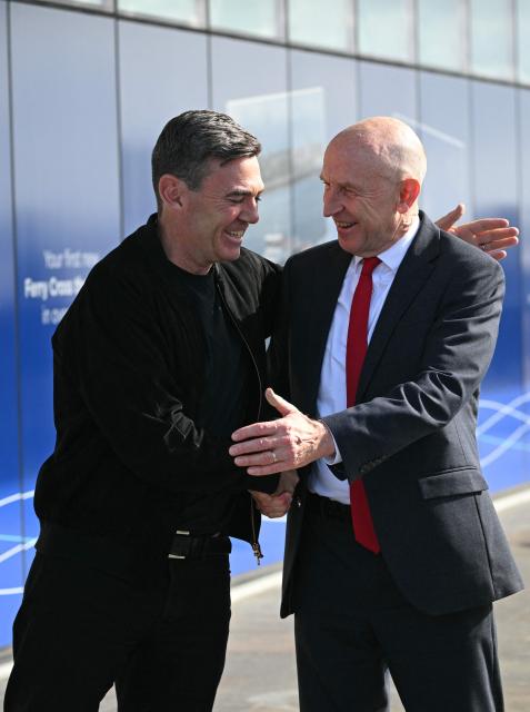Britain's Prime Minister Andy Burnham (L) greets Britain's Chancellor of the Exchequer John Healey (R) as they go to visit the new ferry ahead of the annual Labour Party conference in Liverpool, north-west England, on September 26, 2026. Britain's ruling Labour Party gathers Sunday for its first annual conference under Andy Burnham's leadership, heartened by his start as prime minister but now looking for concrete plans to tackle looming challenges. (Photo by Oli SCARFF / AFP)
