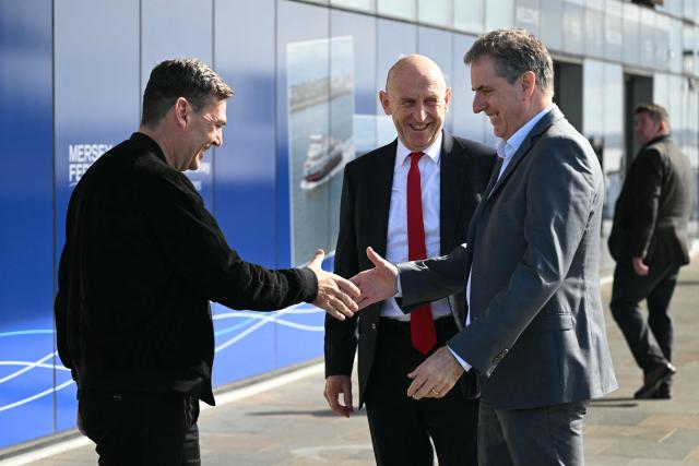 Liverpool mayor Steve Rotheram (R), Britain's Prime Minister Andy Burnham (L) and Britain's Chancellor of the Exchequer John Healey (C) go to see the new ferry ahead of the annual Labour Party conference in Liverpool, north-west England, on September 26, 2026. Britain's ruling Labour Party gathers Sunday for its first annual conference under Andy Burnham's leadership, heartened by his start as prime minister but now looking for concrete plans to tackle looming challenges. (Photo by Oli SCARFF / AFP)