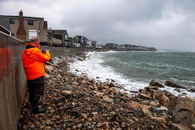 People watch as waves pound the coast during a noreaster as the tide comes in in Scituate, Massachusetts, on September 26, 2026. More than 40 million people in the northeastern United States braced September 25 for heavy rain and strong winds as an unusually powerful storm for the season was forecast to crash into the region. New York, Boston and Philadelphia were all in the firing line of the "Nor'easter" -- so labeled for its northeasterly winds -- as authorities warned of potential flooding, downed trees and damaged power lines. (Photo by Joseph Prezioso / AFP)