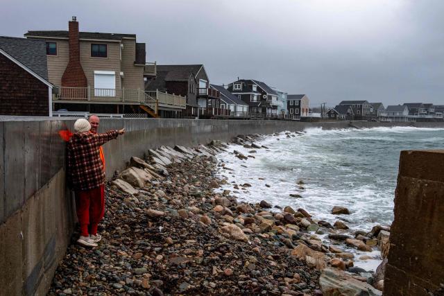 People watch as waves pound the coast during a noreaster as the tide comes in in Scituate, Massachusetts, on September 26, 2026. More than 40 million people in the northeastern United States braced September 25 for heavy rain and strong winds as an unusually powerful storm for the season was forecast to crash into the region. New York, Boston and Philadelphia were all in the firing line of the "Nor'easter" -- so labeled for its northeasterly winds -- as authorities warned of potential flooding, downed trees and damaged power lines. (Photo by Joseph Prezioso / AFP)