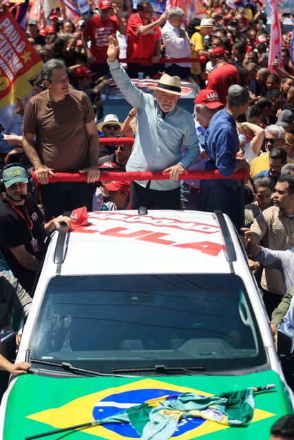 Brazil's President and presidential candidate Luiz Inacio Lula da Silva waves to supporters alongside Governor candidate Fernando Haddad, during a campaign rally at the Sao Miguel Paulista neighbourhood in Sao Paulo, Brazil, on September 26, 2026. Brazil will hold presidential election on October 4, 2026. (Photo by Miguel SCHINCARIOL / AFP)