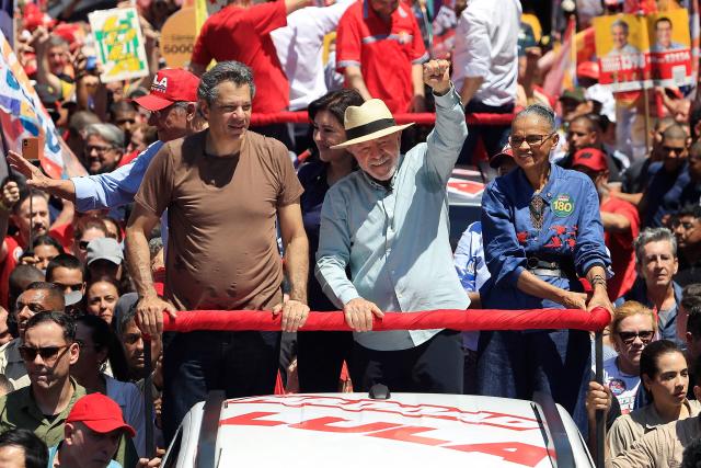 Brazil's President and presidential candidate Luiz Inacio Lula da Silva (C) waves to supporters alongside, Governor candidate Fernando Haddad , and Senator candidate Marina Silva, during a campaign rally at the Sao Miguel Paulista neighbourhood in Sao Paulo, Brazil, on September 26, 2026. Brazil will hold presidential election on October 4, 2026. (Photo by Miguel SCHINCARIOL / AFP)