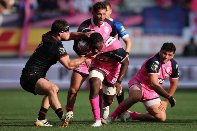 Stade français Paris' French flanker Yoan Tanga (C) fights for the ball with Lyon's French hooker Guillaume Marchand (L) during the French Top14 rugby union match between Stade Francais Paris and Lyon Olympique Universitaire (LOU) at the Jean-Bouin Stadium in Paris on September 26, 2026. (Photo by Anne-Christine POUJOULAT / AFP)