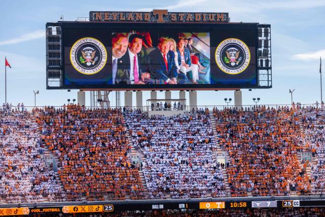 (L-R) US Secretary of Commerce Howard Lutnick, US Senator Bill Hagerty, Republican of Tennessee, US President Donald Trump, and US Senators Marsha Blackburn (L), Republican of Tennessee, are displayed on a video screen as attend the Tennessee Volunteers play the Texas Longhorns in their Southeastern Conference (SEC) opener at Neyland Stadium in Knoxville, Tennessee, on September 26, 2026. (Photo by Jim WATSON / AFP)