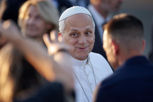 Pope Leo XIV reacts as he is welcomed upon landing at the Tarbes-Lourdes-Pyrenees International Airport, in Tarbes, southwestern France, on September 26, 2026 to travel to Lourdes, the second leg of his papal visit to France. (Photo by Valentine CHAPUIS / AFP)