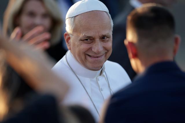 Pope Leo XIV reacts as he is welcomed upon landing at the Tarbes-Lourdes-Pyrenees International Airport, in Tarbes, southwestern France, on September 26, 2026 to travel to Lourdes, the second leg of his papal visit to France. (Photo by Valentine CHAPUIS / AFP)