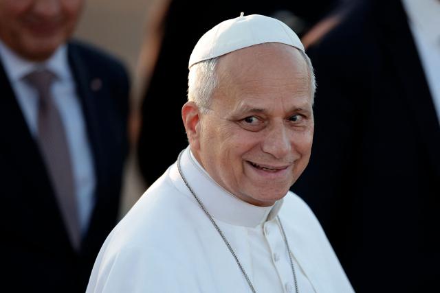 Pope Leo XIV reacts as he is welcomed upon landing at the Tarbes-Lourdes-Pyrenees International Airport, in Tarbes, southwestern France, on September 26, 2026 to travel to Lourdes, the second leg of his papal visit to France. (Photo by Valentine CHAPUIS / AFP)