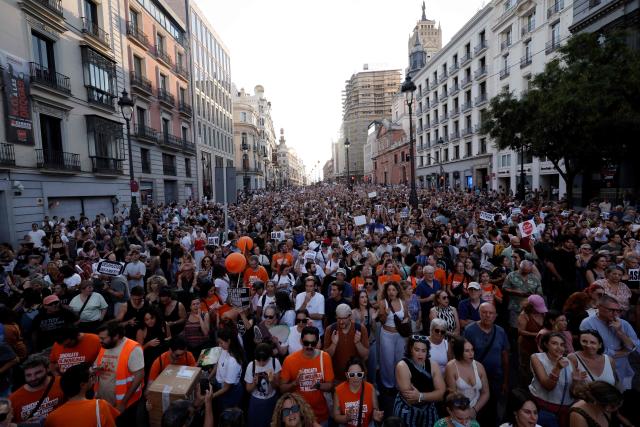 Demonstrators and members of tenants unions (orange t-shirt) take part in a protest against evictions and the housing crisis near the Puerta del Sol plaza in Madrid on September 26, 2026. Spain's main tenants' unions on September 25 urged the government to pass a new law to tackle the country's housing crisis after an 87-year-old was evicted from her Madrid home, sparking nationwide protests. (Photo by Oscar DEL POZO / AFP)