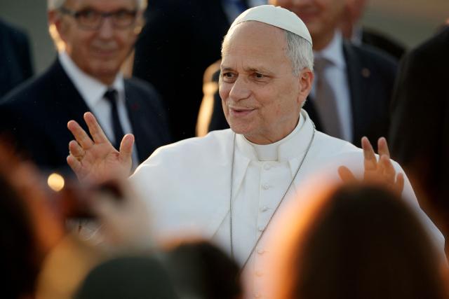 Pope Leo XIV reacts as he is welcomed upon landing at the Tarbes-Lourdes-Pyrenees International Airport, in Tarbes, southwestern France, on September 26, 2026 to travel to Lourdes, the second leg of his papal visit to France. (Photo by Valentine CHAPUIS / AFP)