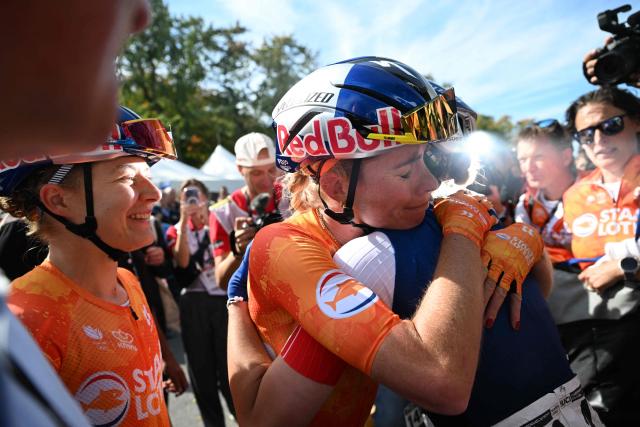 Netherlands's Demi Vollering (C) embraces France's Marie le Net (R) at finish line after winning the Women Elite Road Race during the 2026 Union Cycliste Internationale (UCI) Road World Championships in Montreal, Quebec, on September 26, 2026. (Photo by Andrej Ivanov / AFP)