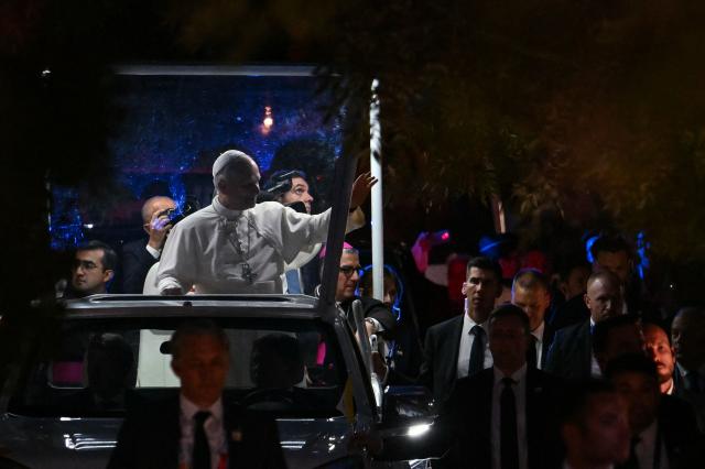 Pope Leo XIV waves to worshippers from the Papamobile (popemobile) on his way to the Grotto of Apparitions at Massabielle in the Sanctuary of Our Lady of Lourdes, southwestern France, on September 26, 2026 on the second day of his visit to France. (Photo by Alberto PIZZOLI / AFP)