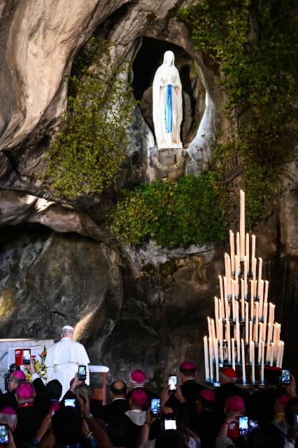 The statue of the Virgin Mary is seens as Pope Leo XIV arrives to lead a prayer with worshippers at the Grotto of Massabielle in the Sanctuary of Our Lady of Lourdes southwestern France, on September 26, 2026 on the second day of his visit to France. (Photo by Alberto PIZZOLI / AFP)