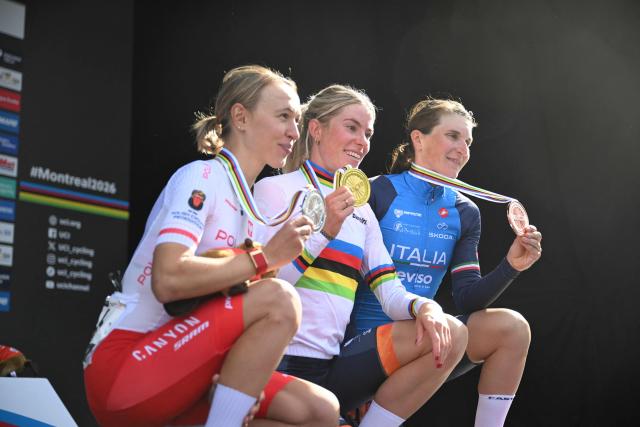 (L/R) Second-placed Katarzyna Niewiadoma of Poland, first-placed Demi Vollering of the Netherlands and third-placed Italian Elisa Longo Borghini pose on thhe podium after the Women's Elite Road Race at the 2026 Union Cycliste Internationale (UCI) Road World Championships in Montreal, Quebec, on September 26, 2026. (Photo by Andrej Ivanov / AFP)