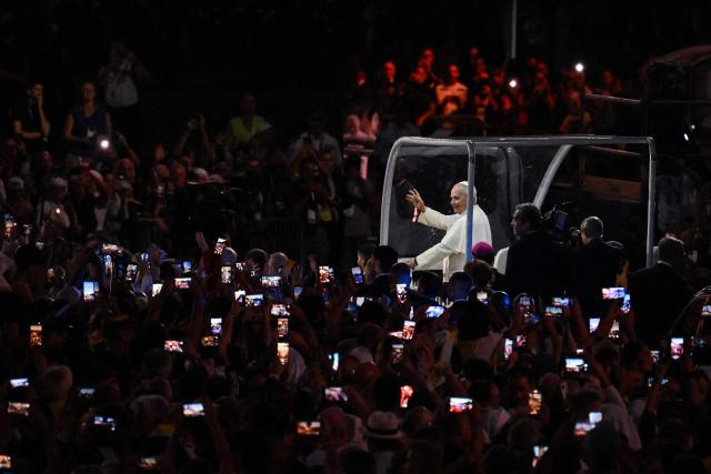 Pope Leo XIV waves to worshippers from the Papamobile (popemobile) on his way to the Grotto of Apparitions at Massabielle in the Sanctuary of Our Lady of Lourdes, southwestern France, on September 26, 2026 on the second day of his visit to France. (Photo by Ed JONES / AFP)