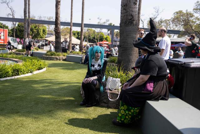 Attendees wearing costumes chat during Comic Con Africa, one of Africa's largest pop culture, fantasy and gaming festivals, at the Johannesburg Expo Centre in Johannesburg on September 26, 2026. Comic Con Africa is a pop culture and gaming convention that brings together fans of comics, films, television, gaming, cosplay and related entertainment, attracting exhibitors, creators and enthusiasts from across Africa and beyond. (Photo by Cecilia Seregni / AFP)