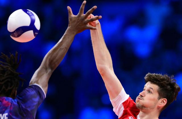Poland's Middle Blocker #34 Szymon Jakubiszak spikes the ball during the CEV EuroVolley 2026 men's gold medal final volleyball match between France and Poland at the Forum of Assago, on September 26, 2026. (Photo by Marco BERTORELLO / AFP)