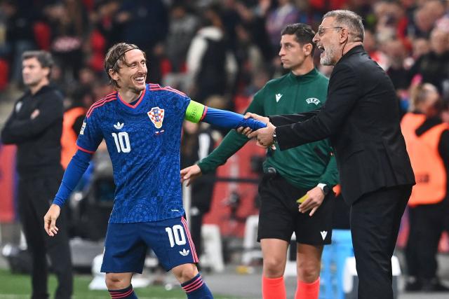 Croatia's midfielder #10 Luka Modric (L) celebrates scoring his team's first goal with Croatia's head coach Slaven Bilic during the UEFA Nations League Group A3 football match between Czech Republic and Croatia in Prague on September 26, 2026. (Photo by Michal Cizek / AFP)