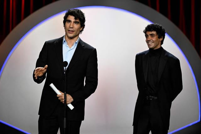 Spanish directors Javier Calvo and Javier Ambrossi (R) talk on stage after winning the Audience Award for their film "La bola negra" during the 74th San Sebastian International Film Festival closing ceremony in the northern Spanish Basque city of San Sebastian on September 26, 2026. (Photo by ANDER GILLENEA / AFP)