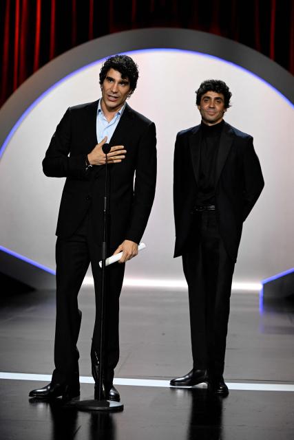 Spanish directors Javier Calvo and Javier Ambrossi (R) talk on stage after winning the Audience Award for their film "La bola negra" during the 74th San Sebastian International Film Festival closing ceremony in the northern Spanish Basque city of San Sebastian on September 26, 2026. (Photo by ANDER GILLENEA / AFP)