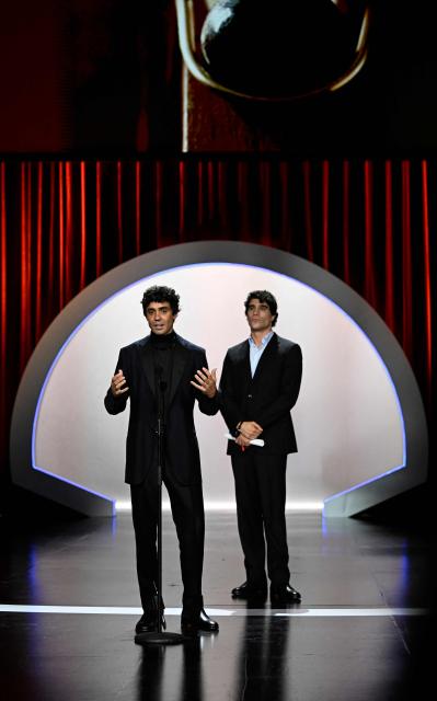 Spanish directors Javier Calvo and Javier Ambrossi (R) talk on stage after winning the Audience Award for their film "La bola negra" during the 74th San Sebastian International Film Festival closing ceremony in the northern Spanish Basque city of San Sebastian on September 26, 2026. (Photo by ANDER GILLENEA / AFP)