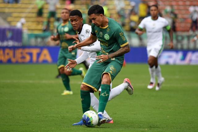 Atletico Nacional's midfielder #35 Matias Lozano and Chapecoense's defender #21 Kauan Faria during a friendly football match between Colombia's Atletico Nacional and Brazil's Chapecoense ahead of the tenth anniversary of the accident, at the Atanasio Girardot Stadium in Medellin, Colombia, on September 26, 2026. On November 28, 2016 the plane flying Chapecoense to Medellin to take on Atletico Nacional in the Copa Sudamericana finals -- the biggest and most unexpected game in the Brazilian team's history- ran out of fuel and went down in the mountains near its destination, killing 71 of the 77 aboard, including 19 players. (Photo by Jaime SALDARRIAGA / AFP)