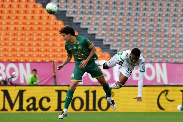 Chapecoense's Spanish midfielder #80 Miguel Carvalho and Atletico Nacional's midfielder #35 Matias Lozano fight for the ball during a friendly football match between Colombia's Atletico Nacional and Brazil's Chapecoense ahead of the tenth anniversary of the accident, at the Atanasio Girardot Stadium in Medellin, Colombia, on September 26, 2026. On November 28, 2016 the plane flying Chapecoense to Medellin to take on Atletico Nacional in the Copa Sudamericana finals -- the biggest and most unexpected game in the Brazilian team's history- ran out of fuel and went down in the mountains near its destination, killing 71 of the 77 aboard, including 19 players. (Photo by Jaime SALDARRIAGA / AFP)