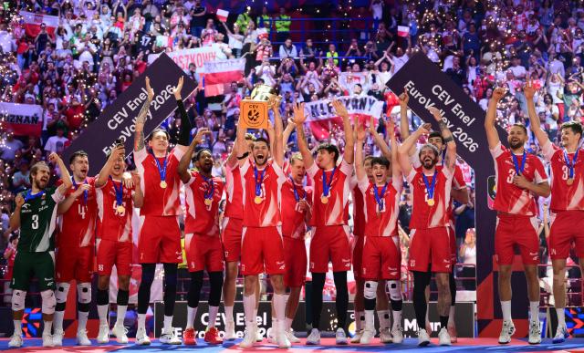 Poland's Opposite Hitter #11 Aleksander Sliwka holds the trophy during the victory ceremony of the CEV EuroVolley 2026 men's finals at the Forum of Assago, on September 26, 2026. (Photo by Marco BERTORELLO / AFP)
