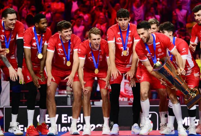 Poland's Opposite Hitter #11 Aleksander Sliwka holds the trophy during the victory ceremony of the CEV EuroVolley 2026 men's finals at the Forum of Assago, on September 26, 2026. (Photo by Marco BERTORELLO / AFP)