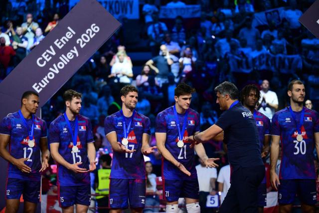 Silver medallists France’s player are congratulated by France Head coach Andrea Giani during the victory ceremony of the CEV EuroVolley 2026 men's finals at the Forum of Assago, on September 26, 2026. (Photo by Marco BERTORELLO / AFP)
