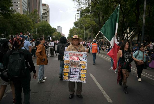 A demonstrator attends a protest during the 12th anniversary of the disappearance of the 43 Ayotzinapa students in Mexico City on September 26, 2026. The 43 students from a teachers' college disappeared on September 26, 2014, while traveling by bus through the state of Guerrero to take part in a demonstration in Mexico City. (Photo by CARL DE SOUZA / AFP)