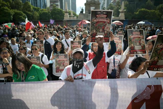 Demonstrators attend a protest during the 12th anniversary of the disappearance of the 43 Ayotzinapa students in Mexico City on September 26, 2026. The 43 students from a teachers' college disappeared on September 26, 2014, while traveling by bus through the state of Guerrero to take part in a demonstration in Mexico City. (Photo by CARL DE SOUZA / AFP)