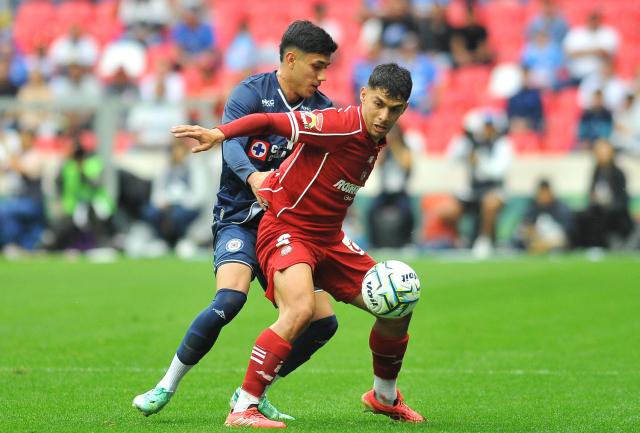 Cruz Azul's defender #03 Omar Campos and Toluca's defender #02 Diego Barbosa fight for the ball during the Liga MX Apertura tournament football match between Cruz Azul and Toluca at the Banorte Stadium in Mexico City on September 26, 2026. (Photo by Victor CRUZ / AFP)