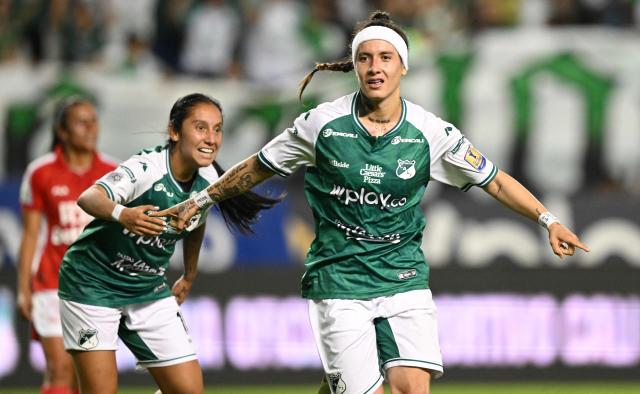 Deportivo Cali's forward #18 Ingrid Guerra celebrates with teammates after scoring her team's fourth goal during the Colombian women's football league second leg final match between Deportivo Cali and Independiente Santa Fe at the Deportivo Cali Stadium in Cali, Colombia on September 26, 2026. (Photo by JOAQUIN SARMIENTO / AFP)