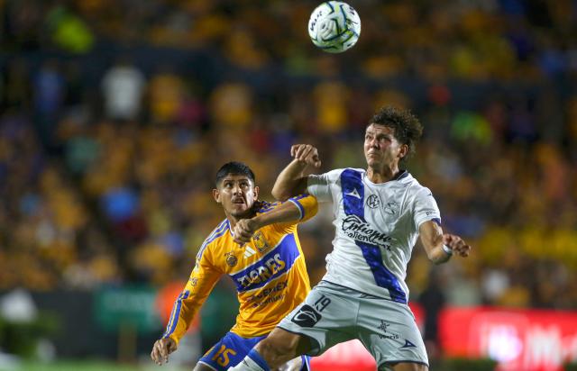 Tigres' Argentine defender #15 Alan Franco and Puebla's Argentine forward #19 Ignacio Maestro Puch fight for the ball during the Liga MX Apertura football match between Tigres and Puebla at the Universitario Stadium in San Nicolas de los Garza, Mexico on September 26, 2026. (Photo by Julio Cesar AGUILAR / AFP)