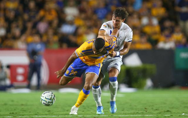 Tigres' Brazilian defender #28 Joaquim Henrique and Puebla's Argentine forward #19 Ignacio Maestro Puch fight for the ball during the Liga MX Apertura football match between Tigres and Puebla at the Universitario Stadium in San Nicolas de los Garza, Mexico on September 26, 2026. (Photo by Julio Cesar AGUILAR / AFP)
