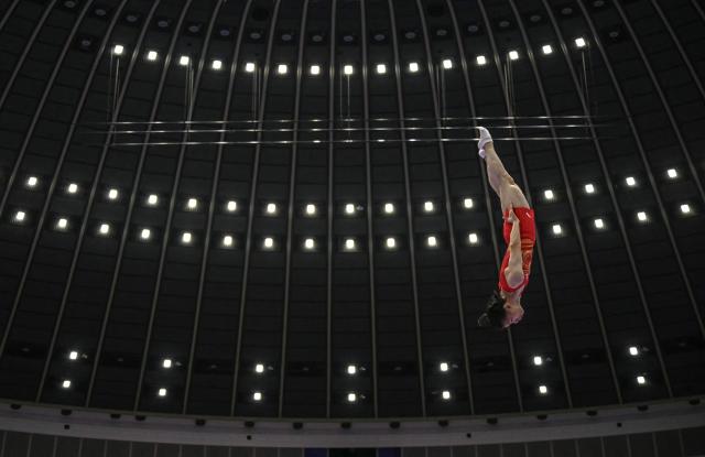 China's Yan Langyu competes in a qualification heat of the men's trampoline gymnastics event during the 2026 Asian Games at the Nagoya City General Gymnasium in Nagoya, Aichi prefecture on September 27, 2026. (Photo by MOHD RASFAN / AFP)