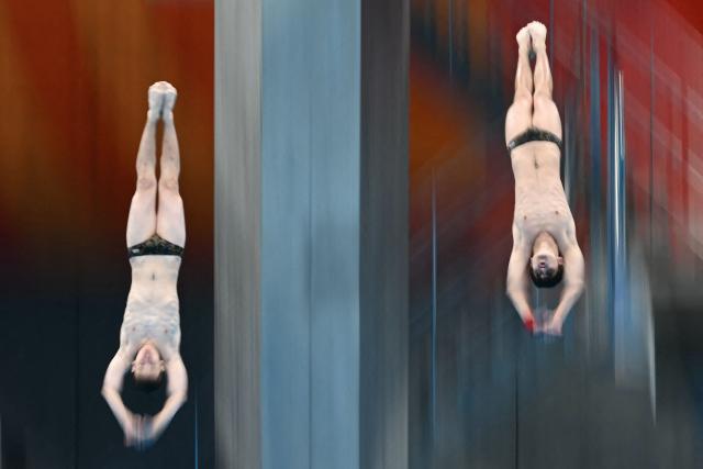 Uzbekistan's Abduvakhab Vakhabov and Amal Mavlyanov compete in the men's synchronised 10m platform final diving event during the 2026 Asian Games at the Tokyo Aquatics Centre in Tokyo on September 27, 2026. (Photo by ANDREW CABALLERO-REYNOLDS / AFP)