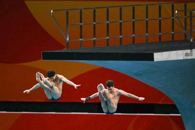 Iran's Sam Vajerhelabad and Seyedmohammad Moghadasi compete in the men's synchronised 10m platform final diving event during the 2026 Asian Games at the Tokyo Aquatics Centre in Tokyo on September 27, 2026. (Photo by ANDREW CABALLERO-REYNOLDS / AFP)