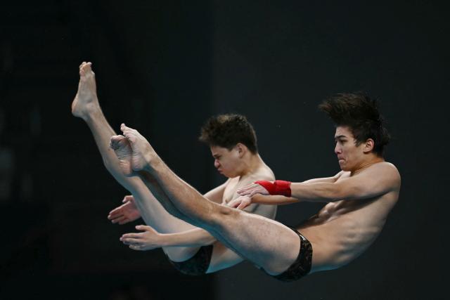Uzbekistan's Abduvakhab Vakhabov and Amal Mavlyanov compete in the men's synchronised 10m platform final diving event during the 2026 Asian Games at the Tokyo Aquatics Centre in Tokyo on September 27, 2026. (Photo by ANDREW CABALLERO-REYNOLDS / AFP)