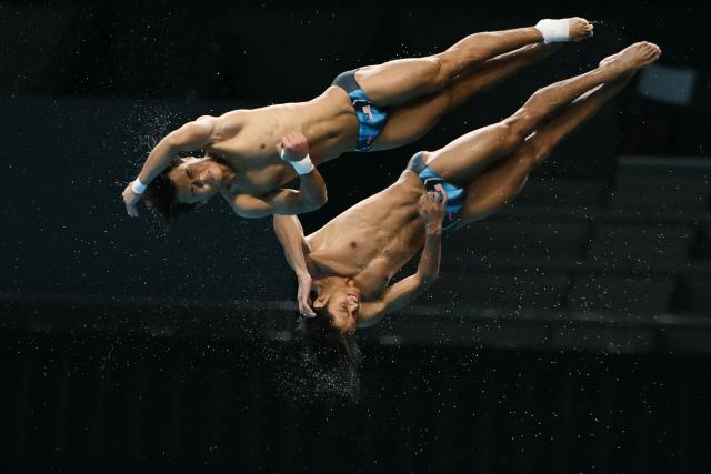 Malaysia's Enrique Harold and Elvis Priestly Clement compete in the men's synchronised 10m platform final diving event during the 2026 Asian Games at the Tokyo Aquatics Centre in Tokyo on September 27, 2026. (Photo by ANDREW CABALLERO-REYNOLDS / AFP)
