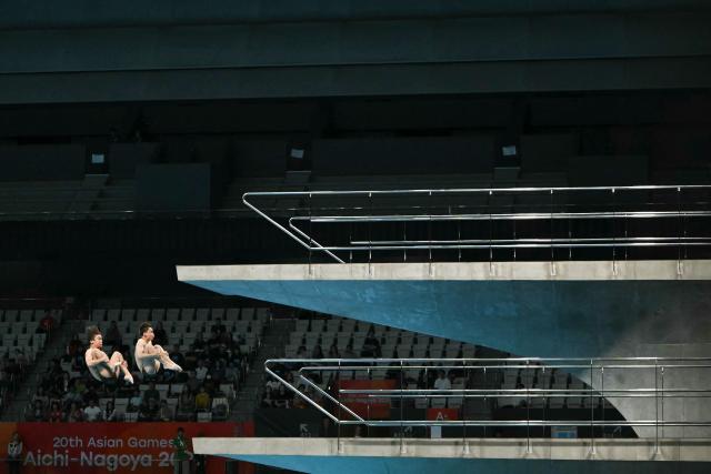 Uzbekistan's Abduvakhab Vakhabov and Amal Mavlyanov compete in the men's synchronised 10m platform final diving event during the 2026 Asian Games at the Tokyo Aquatics Centre in Tokyo on September 27, 2026. (Photo by ANDREW CABALLERO-REYNOLDS / AFP)