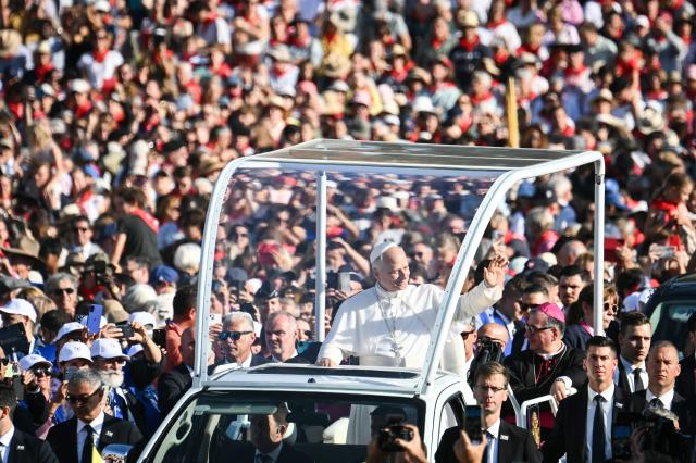 Pope Leo XIV waves to worshippers from the Papamobile (popemobile) as he arrives to celebrate a holy mass at the Prairie of the Shrine of Our Lady of Lourdes, southwestern France, on September 27, 2026 on the third day of his visit to France. (Photo by Alberto PIZZOLI / AFP)