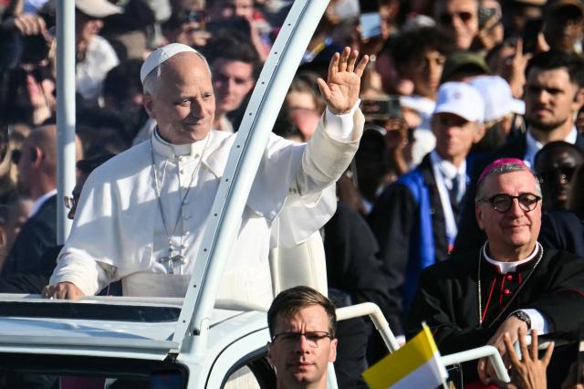 Pope Leo XIV waves to worshippers as he arrives on board of the Papamobile (popemobile) to celebrate a holy mass at the Prairie of the Shrine of Our Lady of Lourdes, southwestern France, on September 27, 2026 on the third day of his visit to France. (Photo by Alberto PIZZOLI / AFP)