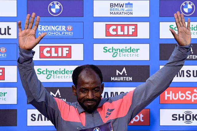 Ethiopia's Guye Adola celebrates on the podium after winning the 52nd edition of the Berlin Marathon in Berlin, Germany on September 27, 2026. (Photo by John MACDOUGALL / AFP)