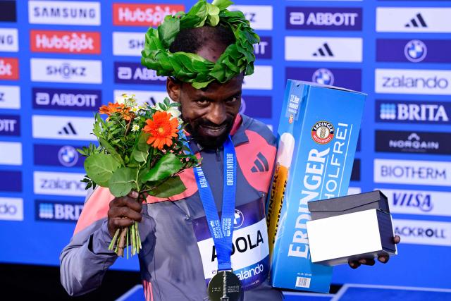 Ethiopia's Guye Adola celebrates on the podium after winning the 52nd edition of the Berlin Marathon in Berlin, Germany on September 27, 2026. (Photo by John MACDOUGALL / AFP)