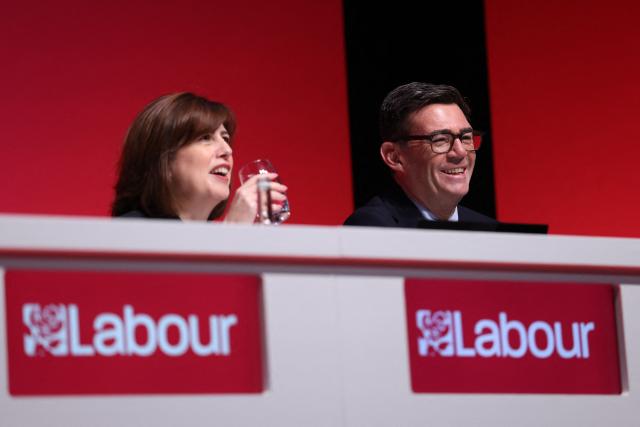 Deputy Labour party leader Lucy Powell (L) and Britain's Prime Minister Andy Burnham (R) chat on stage on the first day of the annual Labour Party conference in Liverpool, north-west England, on September 27, 2026. Britain's ruling Labour Party gathers Sunday for its first annual conference under Andy Burnham's leadership, heartened by his start as prime minister but now looking for concrete plans to tackle looming challenges. (Photo by Darren Staples / AFP)